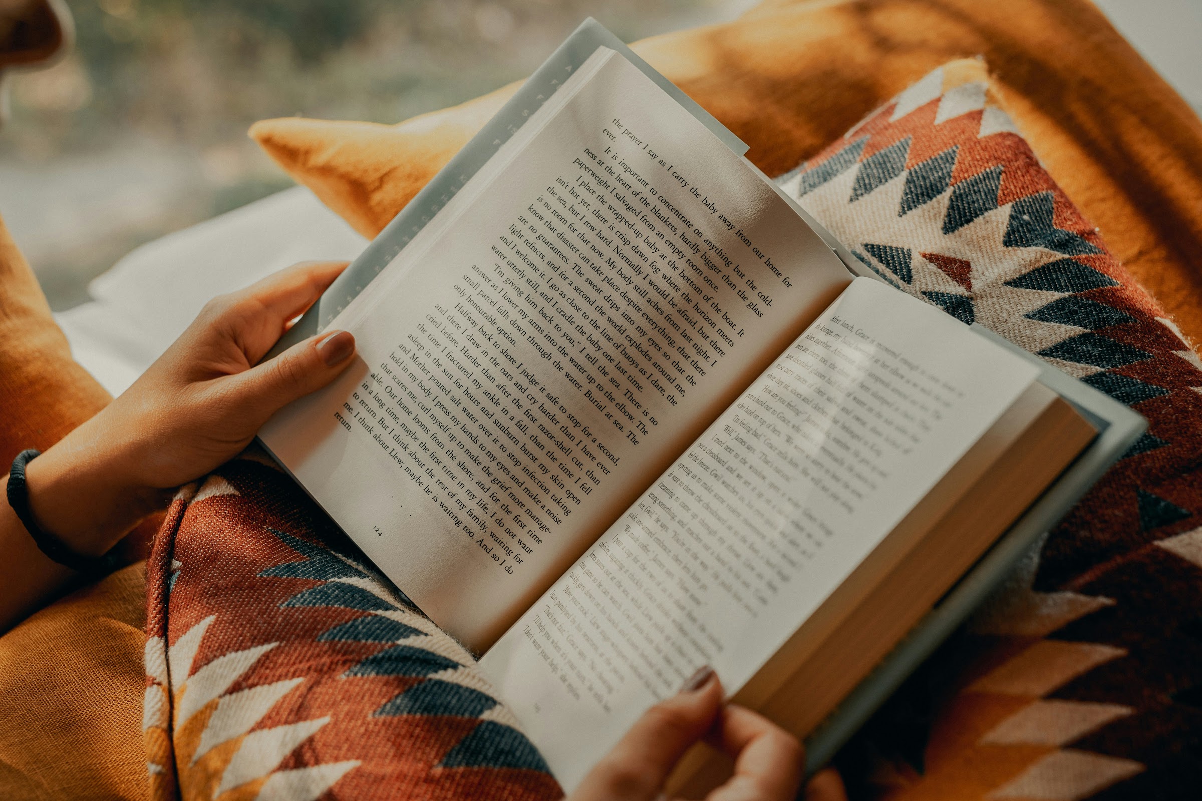 A stack of well-read books on a wooden table